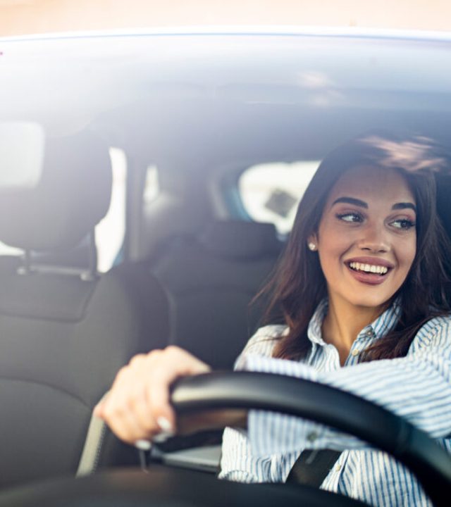 Happy,Woman,Driving,A,Car,And,Smiling.,Cute,Young,Success